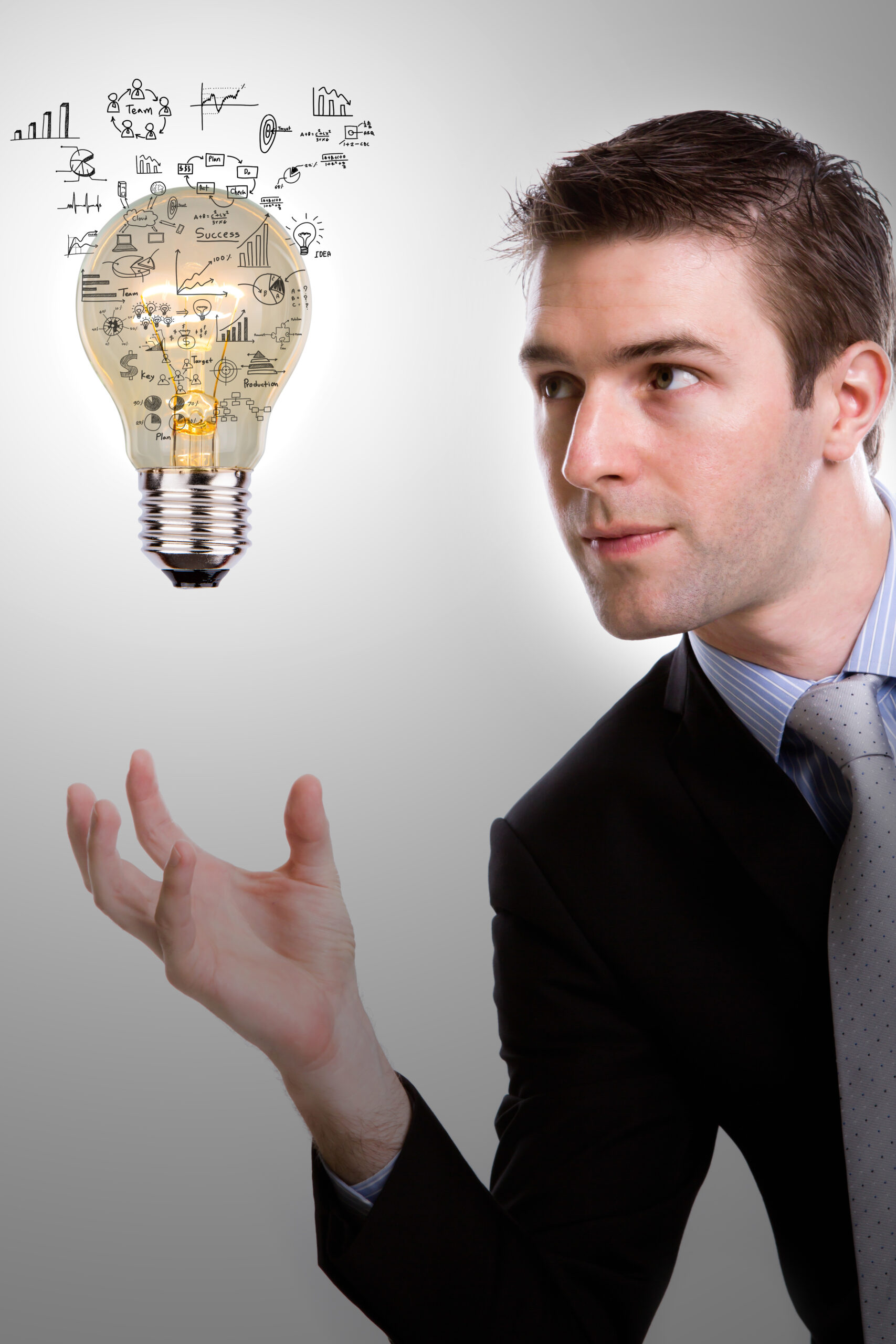 Business man holding light bulb with business concept inside
